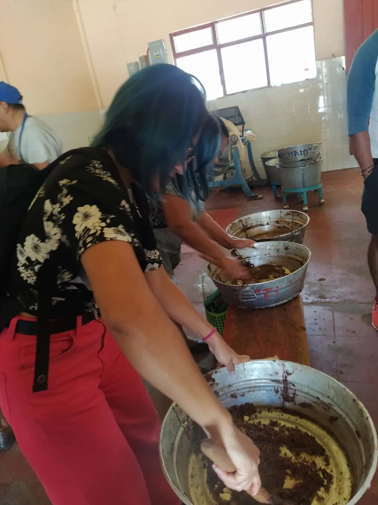 locals mixing their spices in with freshly produced cacao paste.